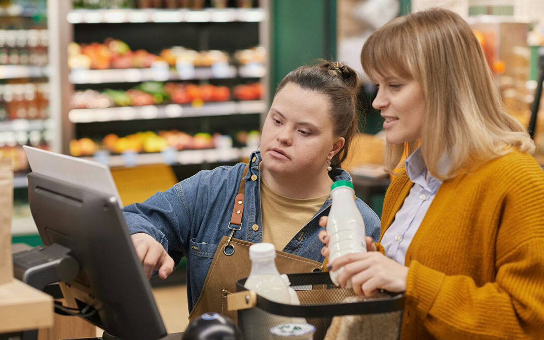 Teen girl with disabilities learning how to self-checkout at the grovery store