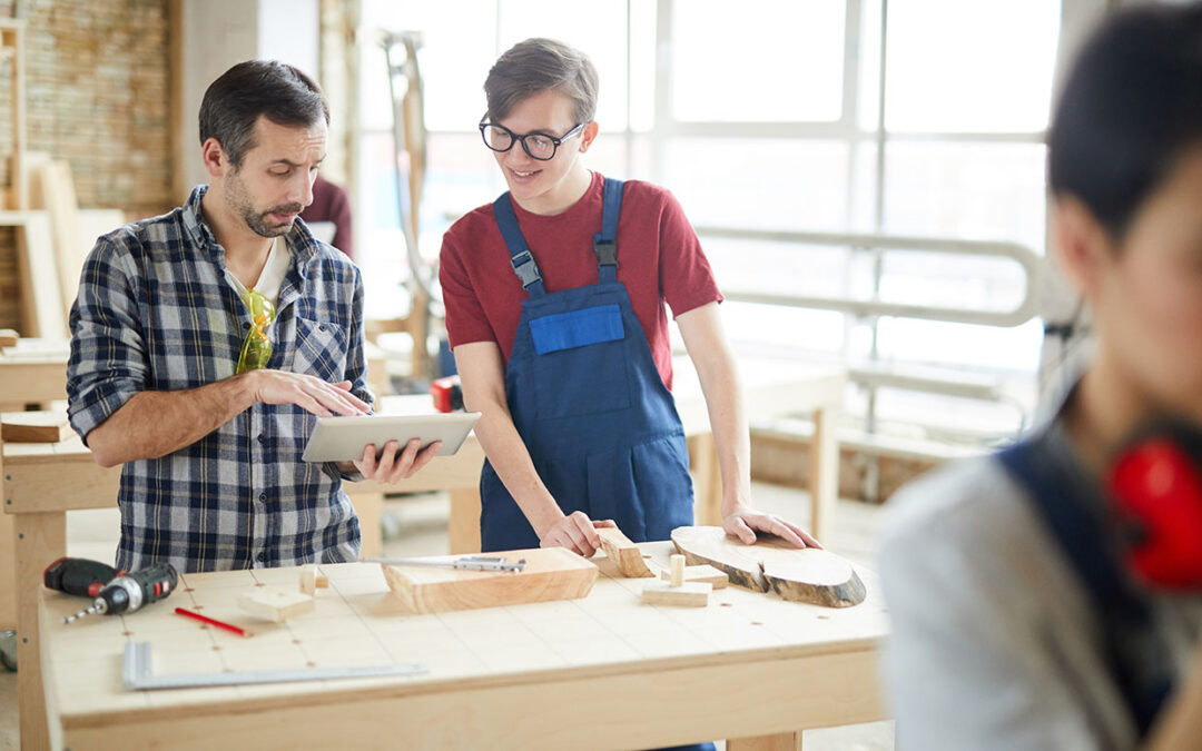 Young adult male learning about being a carpenter in WBL internship